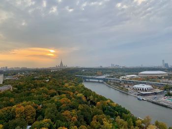High angle view of river and cityscape against sky at sunset