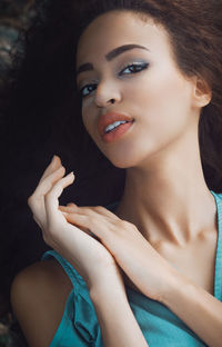 High angle view portrait of young woman lying on floor at home