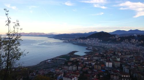 High angle view of townscape by sea against sky