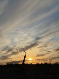 Scenic view of silhouette land against sky during sunset