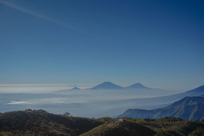 Scenic view of mountains against clear blue sky