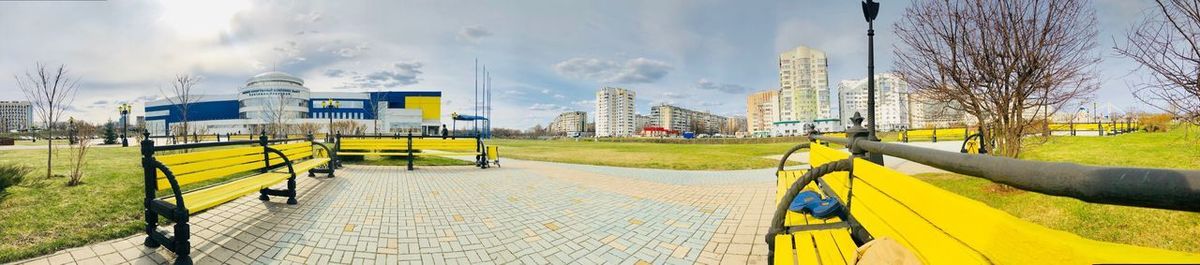 Panoramic view of city street against sky