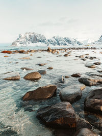 Rocks on sea shore against sky