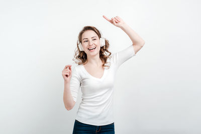 Portrait of a smiling young woman against white background