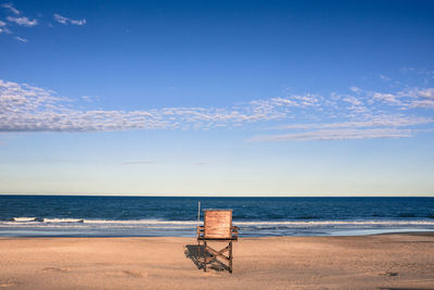 Lifeguard hut at beach against sky