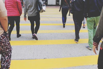 Low section of people walking on road