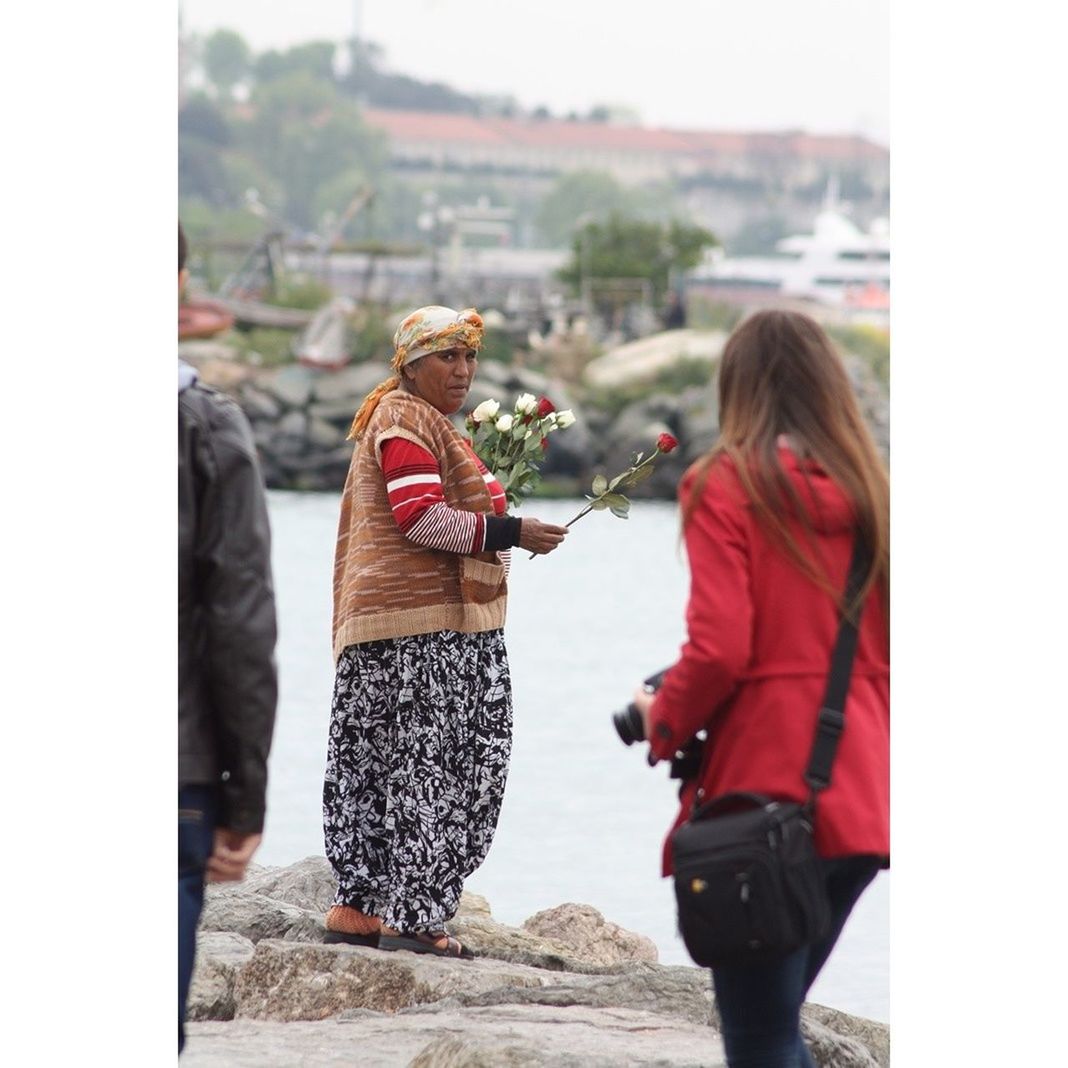 rear view, lifestyles, transfer print, person, leisure activity, men, casual clothing, togetherness, auto post production filter, focus on foreground, full length, standing, bonding, love, walking, street, warm clothing