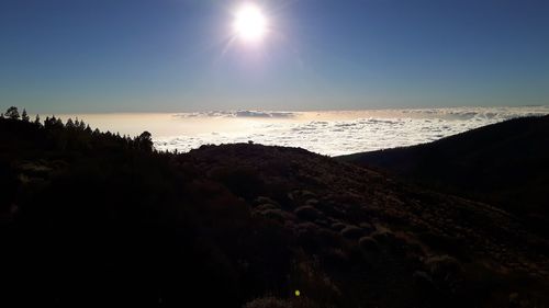 Scenic view of sea against bright sun