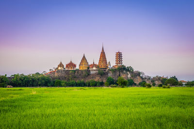 View of temple on field against sky