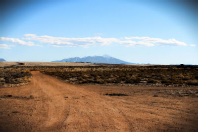 Scenic view of landscape against cloudy sky