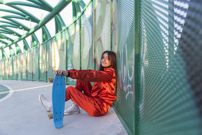 Portrait of young woman sitting outdoors