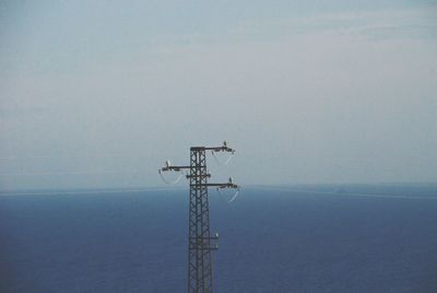 Low angle view of communications tower against sky