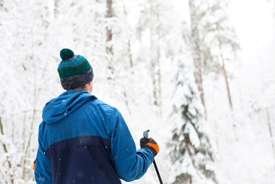 Rear view of man on snow covered land