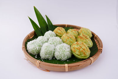 High angle view of fresh green leaves on white background