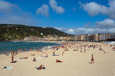 People at beach against sky