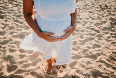 Low section of woman standing on beach