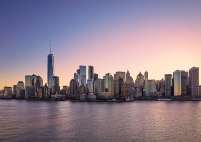 Manhattan skyline and one world trade center at sunrise.