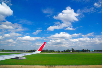 Airplane on runway against sky