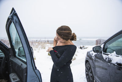 Woman going surfing during winter snow