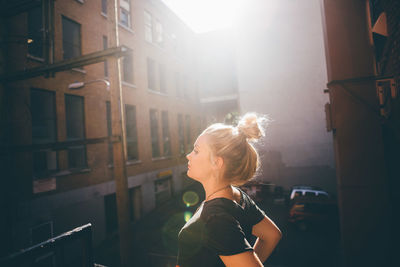 Side view of young woman in city