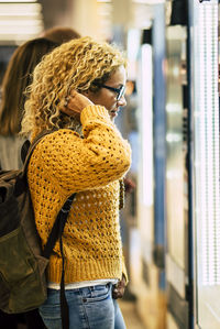 Rear view of woman standing in city