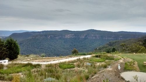 Panoramic shot of countryside landscape against mountain range