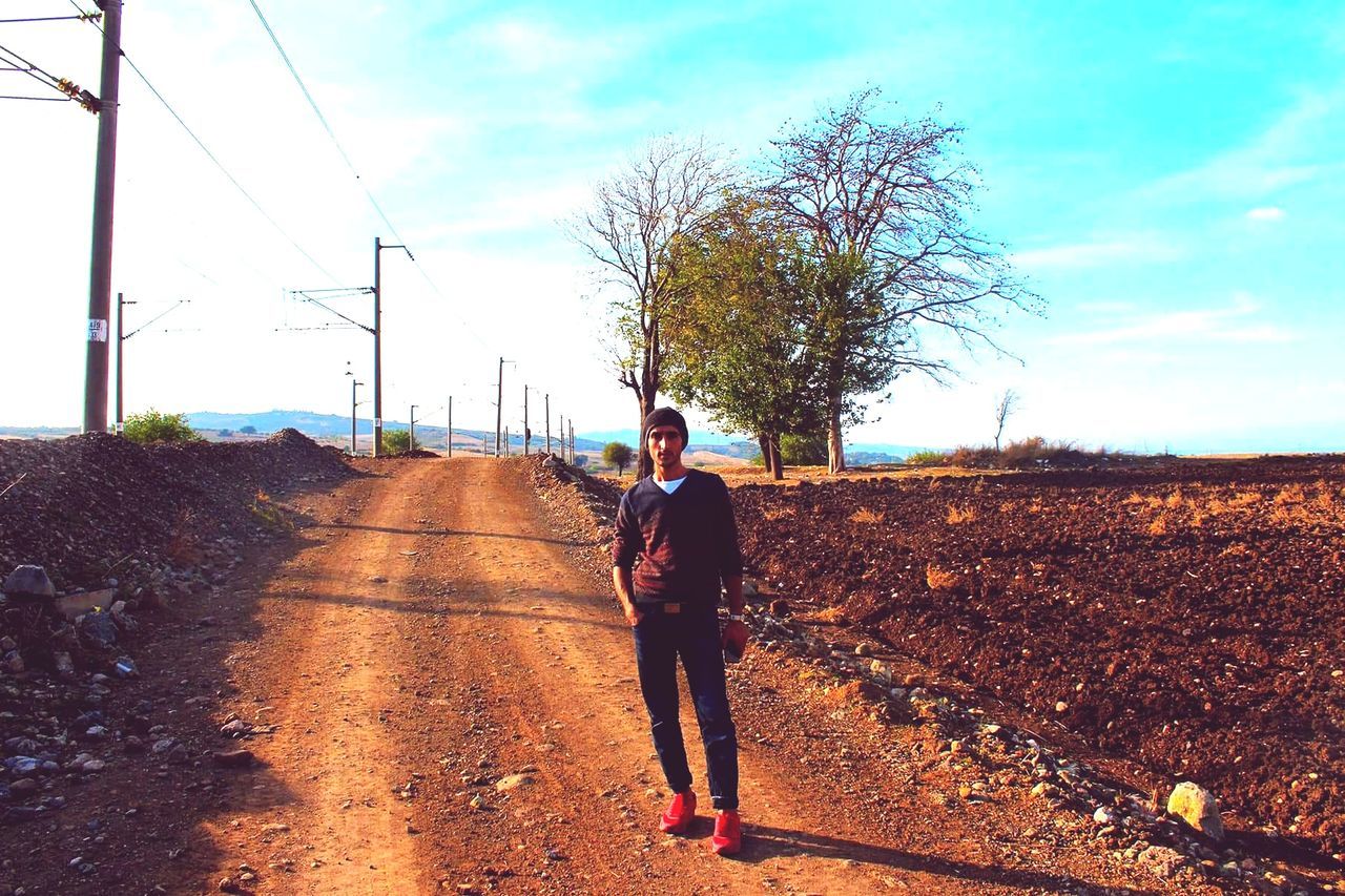 full length, sky, real people, one person, walking, road, day, outdoors, nature, electricity pylon, tree, people