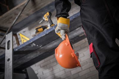 Close-up of man working with umbrella