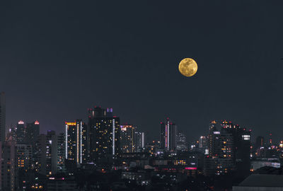 Aerial view of illuminated cityscape against sky at night