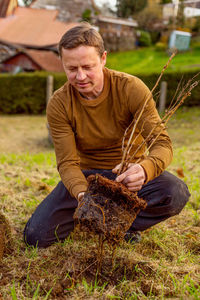 Man plants tree in the garden. nature, environment and ecology concept.