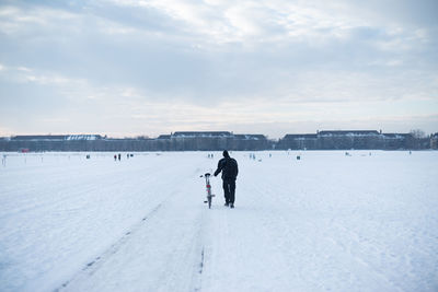 People standing on snow covered landscape