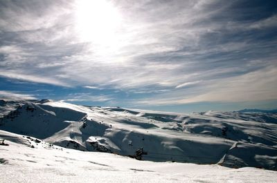 Scenic view of snow covered mountains against sky