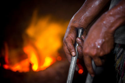 Close-up of hand holding bonfire