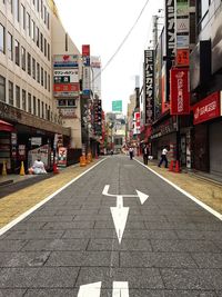 Road signs in city against sky