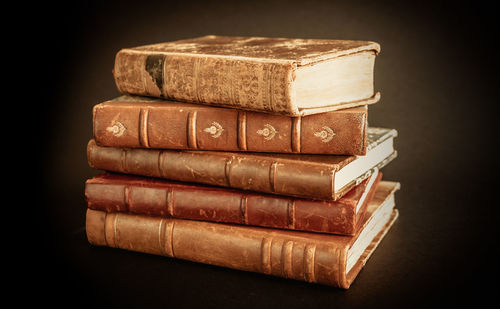 Close-up of stack of food on table against black background