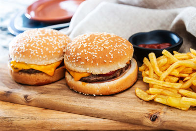 Close-up of burger and french fries on wooden table