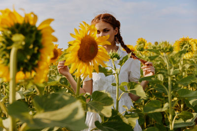 Portrait of young woman holding flowers