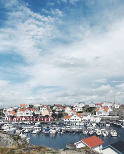 Town by sea against sky