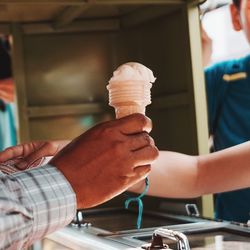 Midsection of man holding ice cream