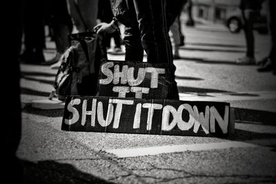 Low section of man walking on street