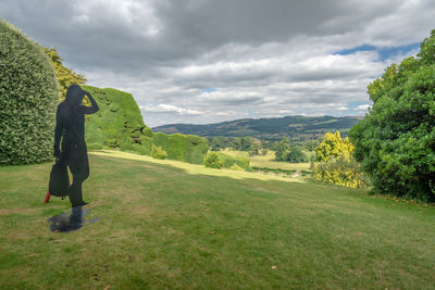 Man standing on field against sky