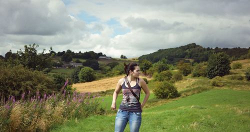 Rear view of woman standing on field