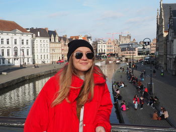 Portrait of woman standing in city