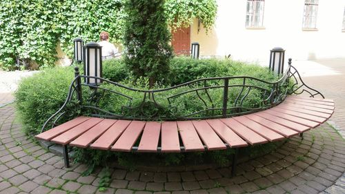 Empty benches against built structure