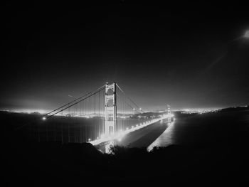 Illuminated bridge at night