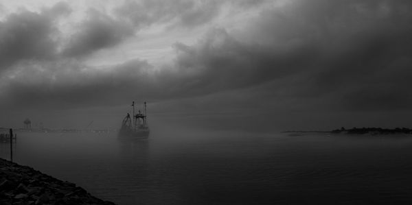 Scenic view of sea against cloudy sky