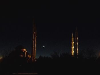 Facade of mosque against the sky at night