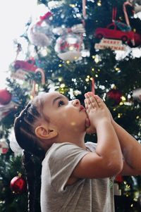 Portrait of boy looking up on tree