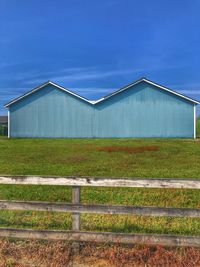 Built structure on field against blue sky