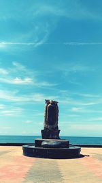 Stack of stone on beach against sky